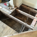 Invasive investigation of dry rot in sub floor void, timber joists and floor boards. Works are often complicated by presence of services such as electric cables.